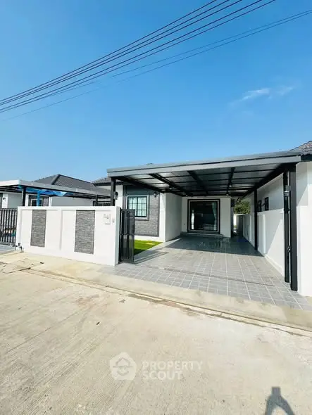 Modern single-story home with spacious driveway and sleek design