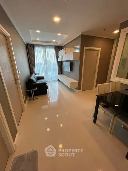 Modern living room with sleek furniture and large windows in a stylish apartment.