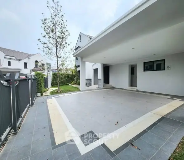 Spacious modern home with large driveway and elegant exterior design.