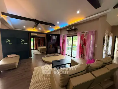Luxurious open-plan living room with modern decor and pool view, perfect for relaxation and entertainment.