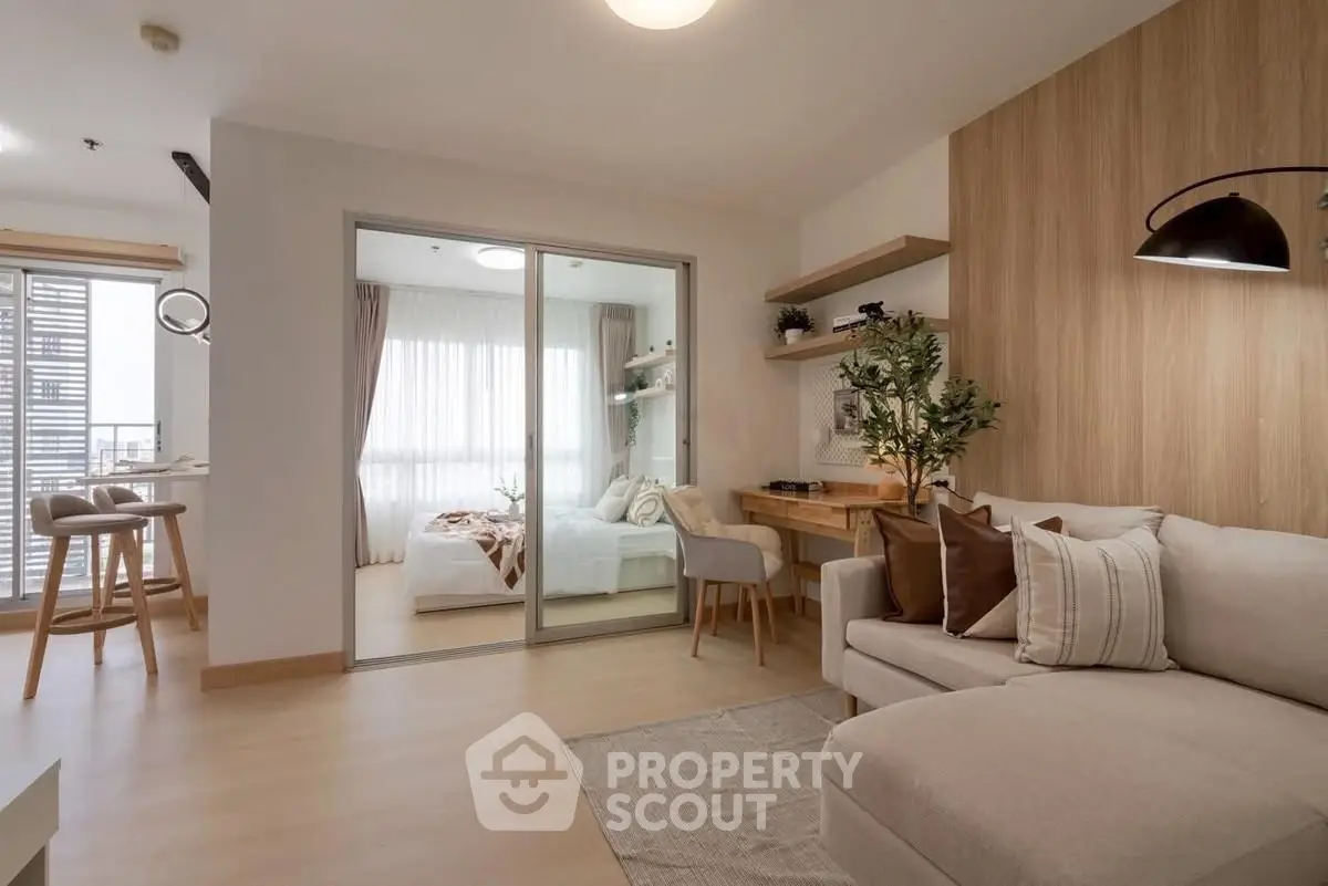 Modern living room with cozy sofa and stylish decor in open layout apartment.