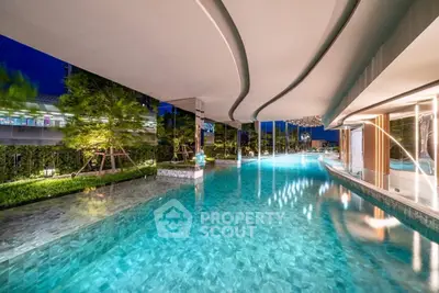 Luxurious modern swimming pool with elegant design and ambient lighting in a high-end residential complex.
