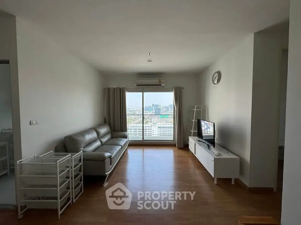 Spacious living room with city view, modern sofa, and sleek TV stand.