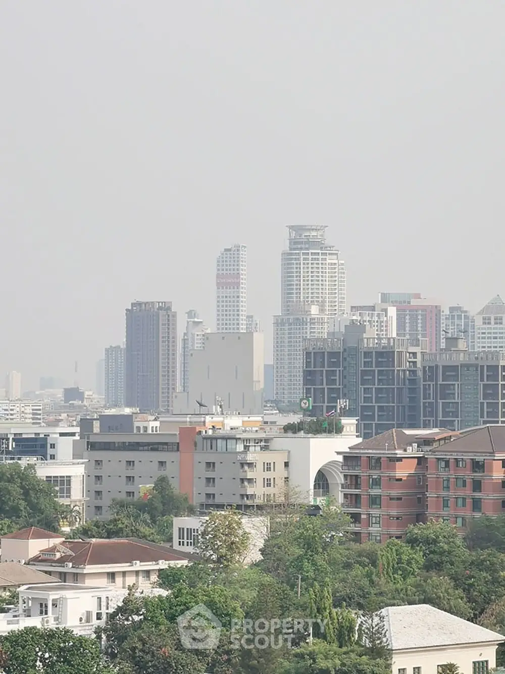 Stunning cityscape view showcasing modern high-rise buildings and lush greenery.