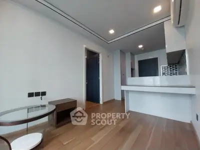 Modern minimalist living room with wooden flooring and sleek furniture