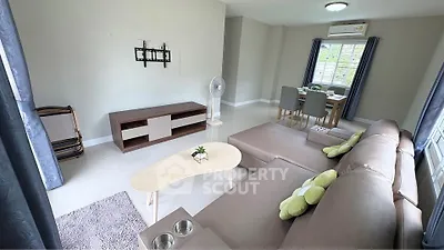 Spacious living room with modern furniture and dining area, perfect for family gatherings.