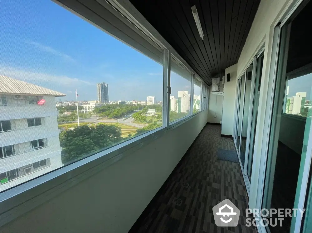 Spacious balcony with panoramic city view in modern apartment