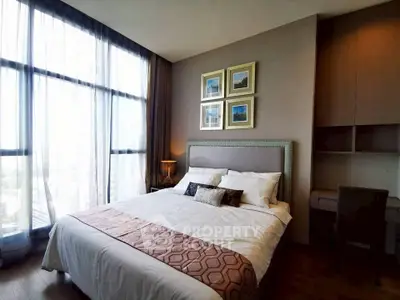 Luxurious bedroom with large windows and elegant decor in modern apartment