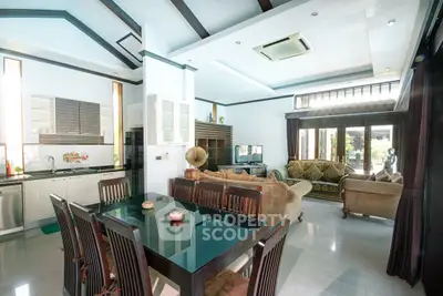 Spacious open-plan living and dining area with modern kitchen and elegant furnishings.