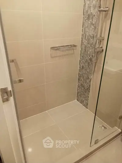 Modern bathroom shower with sleek tile design and glass door