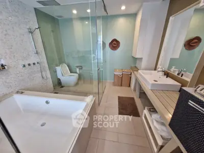 Luxurious modern bathroom with spacious bathtub and glass shower enclosure