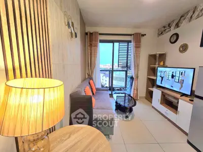 Modern living room with stylish decor and city view balcony, featuring a cozy sofa and flat-screen TV.