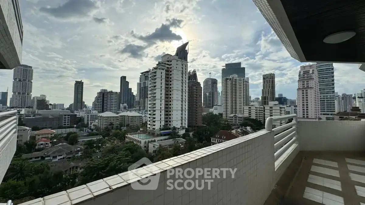 Stunning cityscape view from a high-rise balcony in a vibrant urban setting.