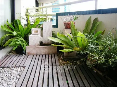 Charming balcony with lush greenery and modern decor, perfect for relaxation and urban gardening.