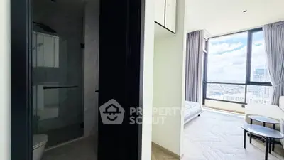 Modern apartment with spacious bedroom and city view, featuring sleek design and large windows.