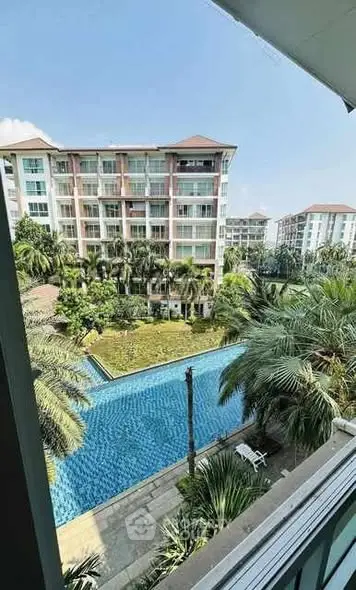 Stunning apartment view overlooking a luxurious pool and lush garden.