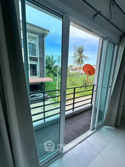 Modern apartment balcony with sliding glass doors and scenic view