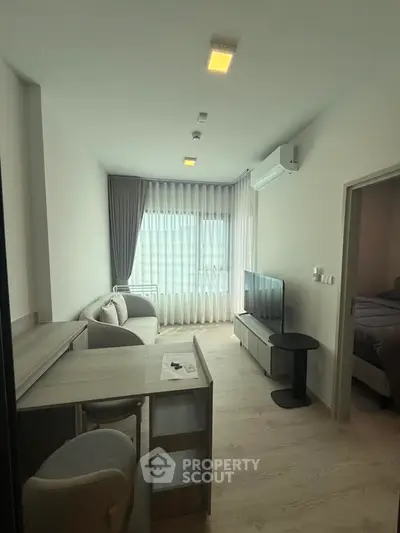 Modern living room with natural light, stylish furniture, and sleek design in a contemporary apartment.