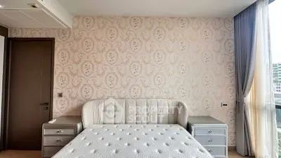 Luxurious bedroom with elegant wallpaper and plush bed in modern apartment