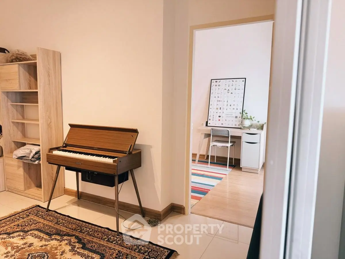Charming interior with a stylish piano and cozy study area, perfect for music and work enthusiasts.