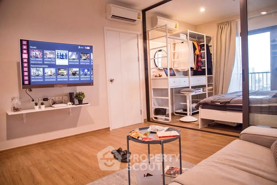 Modern living room with wall-mounted TV and stylish bedroom view