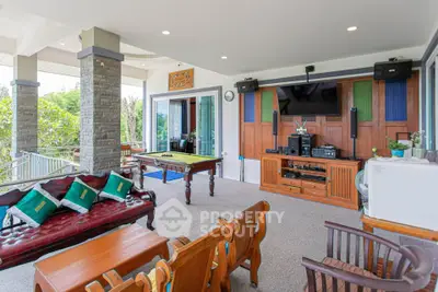 Spacious living area with pool table and entertainment system, perfect for relaxation and gatherings.