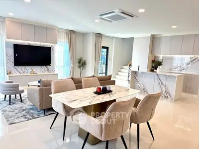 Luxurious open-plan living room with modern kitchen and elegant dining area