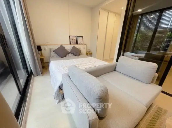 Cozy bedroom with modern decor and large windows for natural light