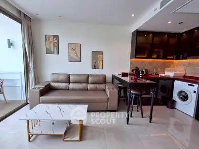 Modern living room with stylish kitchen, featuring sleek furniture and appliances, perfect for urban living.