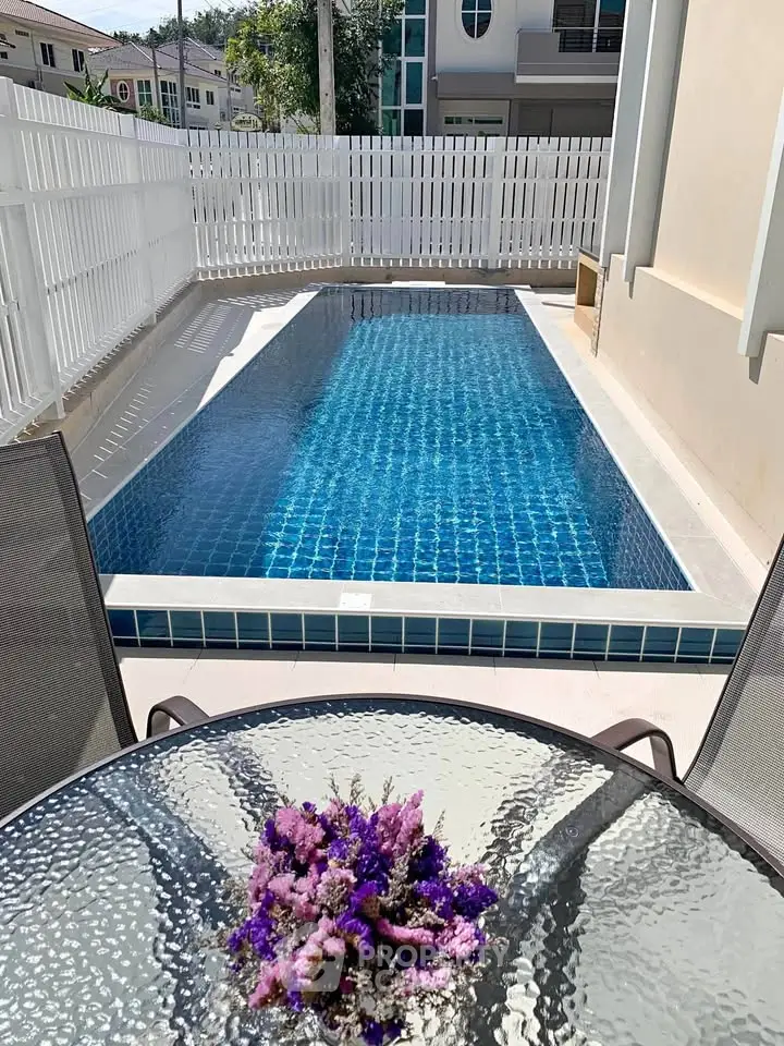 Charming private pool with modern design and cozy outdoor seating area, perfect for relaxation.