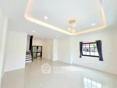 Spacious modern living room with elegant lighting and large windows in a contemporary home.