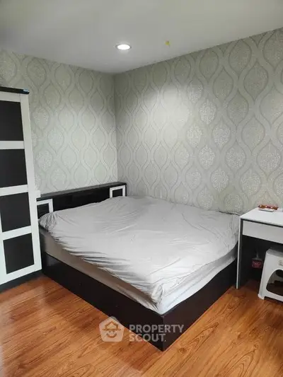 Cozy bedroom with modern decor and wooden flooring