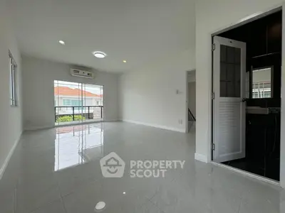 Spacious modern living room with glossy tile flooring and natural light