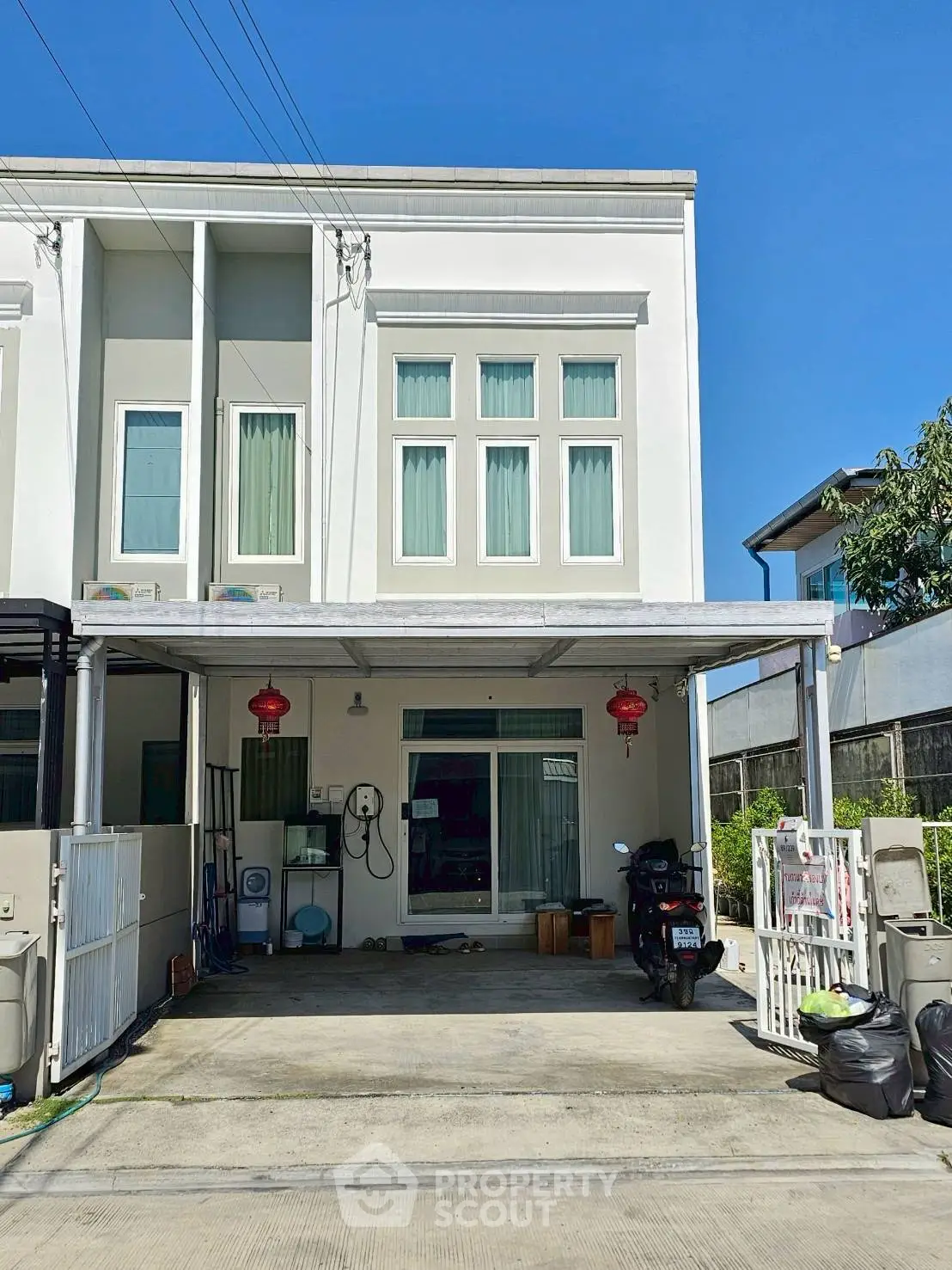 Modern townhouse with spacious driveway and contemporary facade.