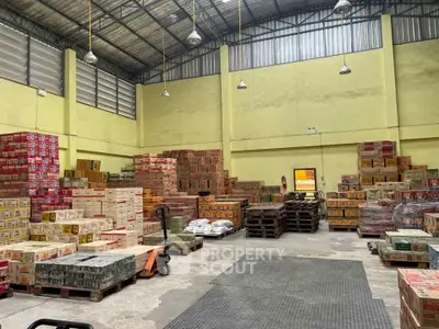 Spacious warehouse interior with stacked boxes and pallets, ideal for storage and distribution needs.
