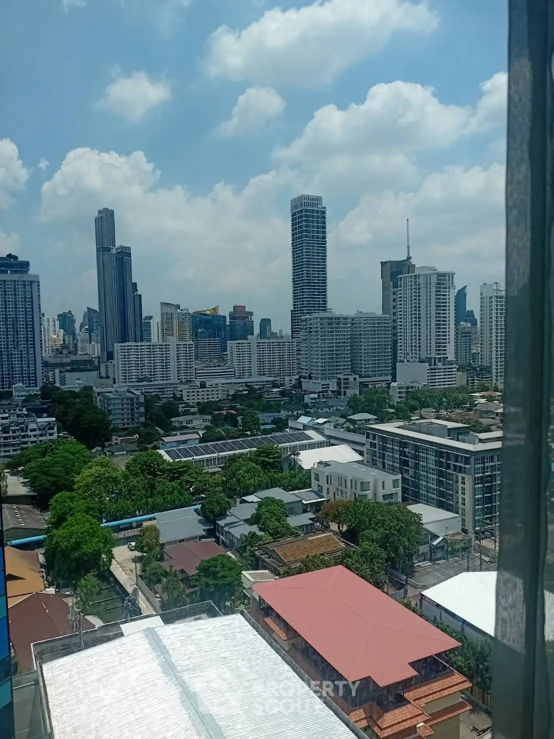 Stunning cityscape view from a high-rise apartment, showcasing modern skyscrapers and urban landscape.