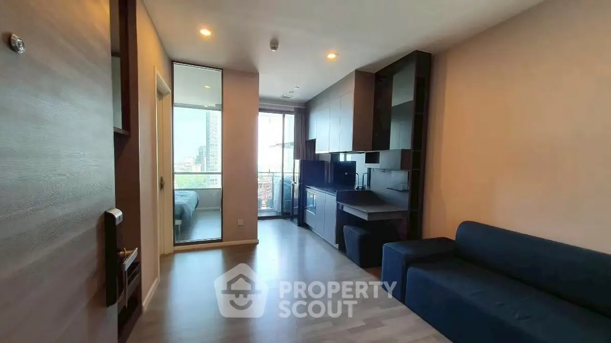Modern apartment interior with open layout and city view from balcony.