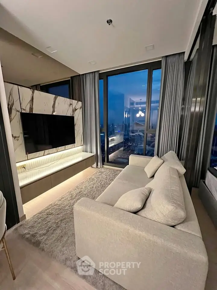 Luxurious living room with modern decor and stunning city view through large windows.