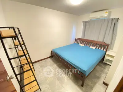 Cozy bedroom with modern furniture and air conditioning, perfect for comfortable living.