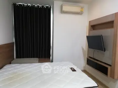 Modern bedroom with wall-mounted TV and air conditioning