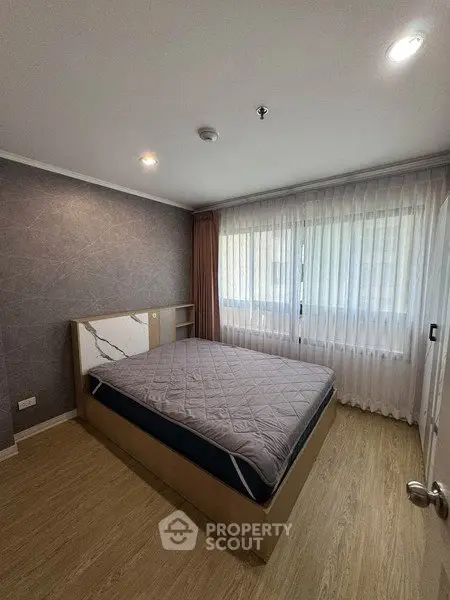 Modern bedroom with large window and stylish decor