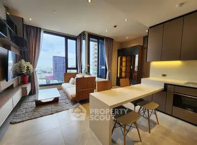 Modern open-plan living room with kitchen and city view