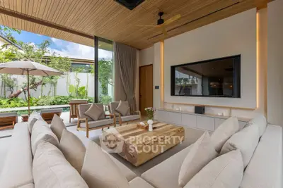 Luxurious living room with modern decor and garden view, featuring elegant furniture and natural light.