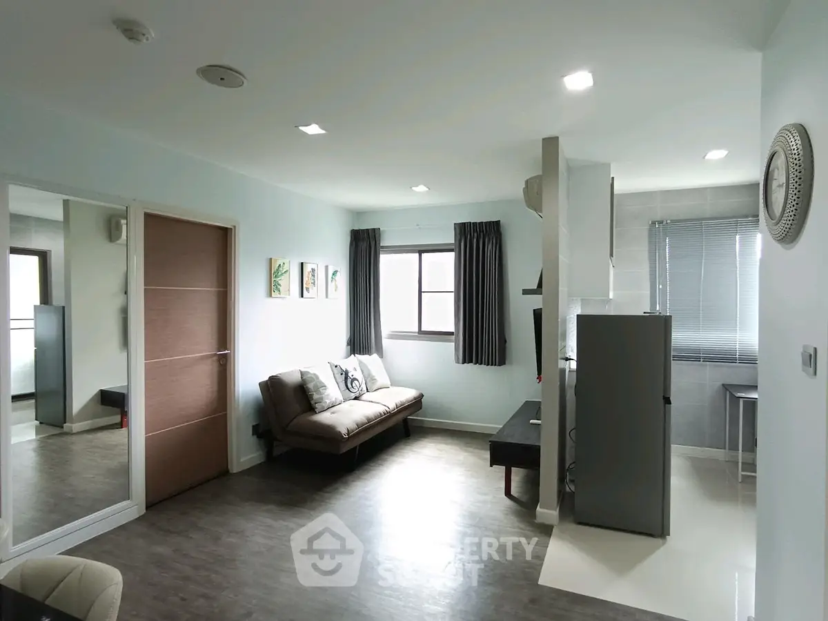 Modern living room with sleek design and natural light, featuring a comfortable sofa and stylish decor.