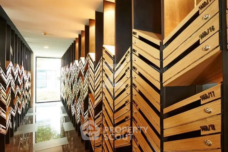 Modern apartment building entrance with stylish mailboxes and sleek design.