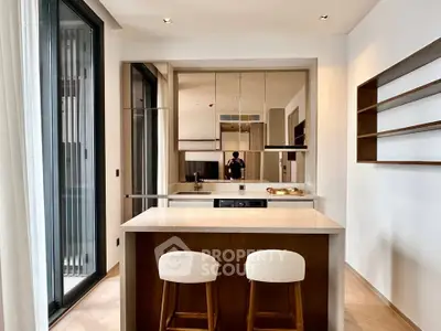 Modern kitchen with sleek design and open layout, featuring a stylish island and high-end appliances.