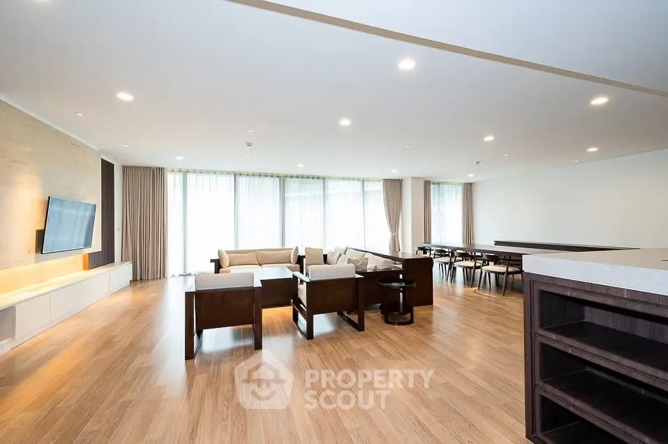 Spacious modern living room with elegant wooden flooring and stylish furniture