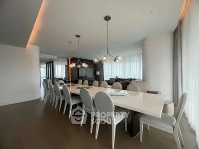 Luxurious modern dining room with elegant lighting and spacious seating in a high-end apartment.