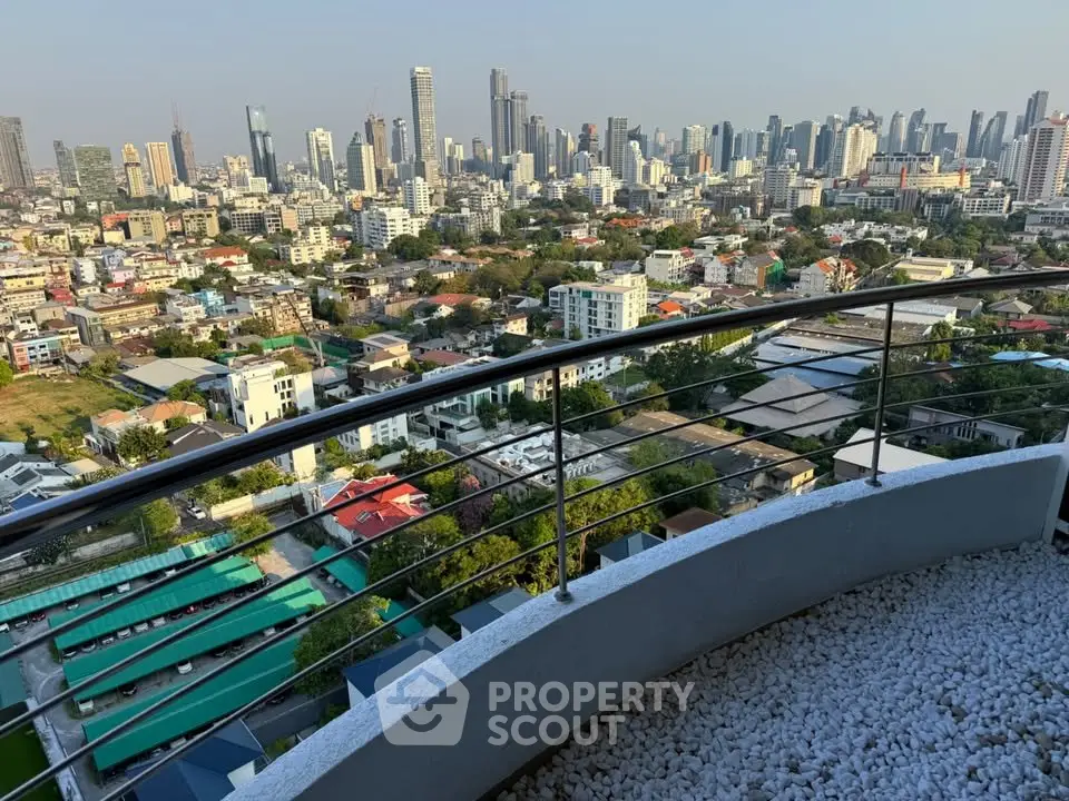 Stunning cityscape view from a high-rise balcony with modern railing and urban skyline.