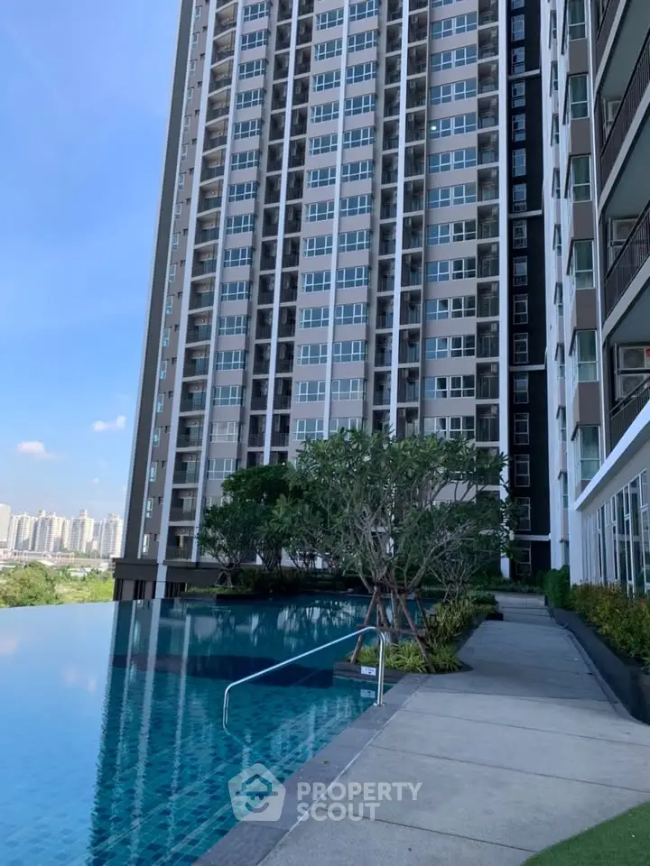 Luxurious high-rise building with stunning infinity pool and cityscape view.